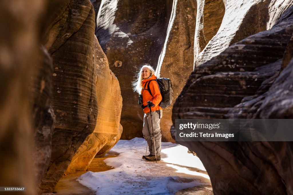 USA, Utah, Escalante, Woman hiking in slot canyon in Grand Staircase-Escalante National Monument