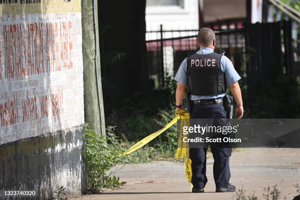Police secure the scene of a shooting on June 15, 2021 in the Englewood neighborhood of Chicago, Illinois. Four people were killed at a home during...