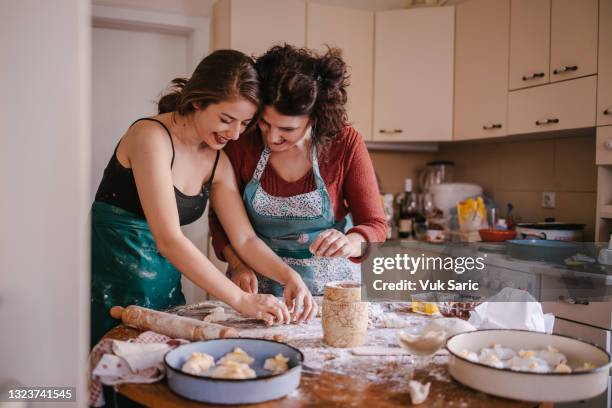 mom and daughter in the kitchen making crescent rolls - gluten free stock pictures, royalty-free photos & images