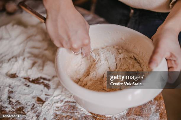 woman mixing dough with the wooden spoon - mixing spoon stock pictures, royalty-free photos & images