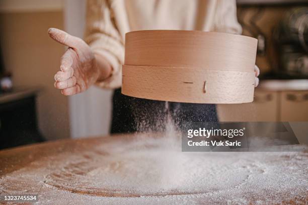 woman sowing flour with a sieve - sifting stock pictures, royalty-free photos & images