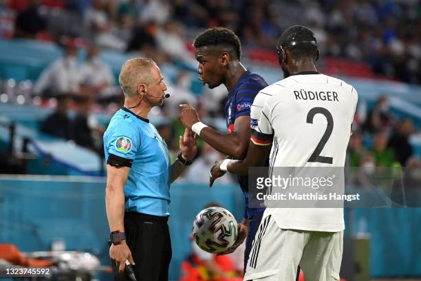 Paul Pogba of France interacts with Assistant Referee, Juan Carlos Yuste after a challenge with Antonio Ruediger of Germany during the UEFA Euro 2020...