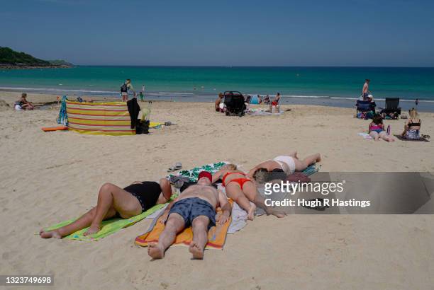 Two days after the end of the G7 Summit in Carbis Bay, a family of holiday makers relax on the beach on June 15, 2021 in Carbis Bay, England. UK...
