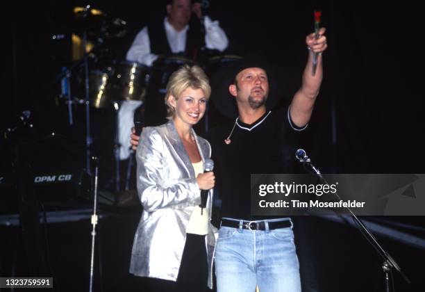 Faith Hill and Tim McGraw perform during the George Strait Music Festival at Oakland Coliseum on April 26, 1998 in Oakland, California.