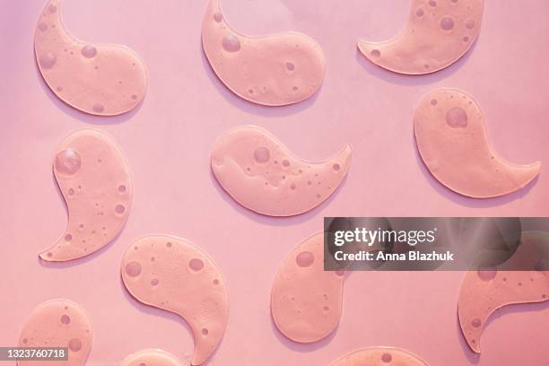 pattern of eye patches over pink background. hydrogel cosmetic eye patch. flat lay, top view. - one eyed stock pictures, royalty-free photos & images