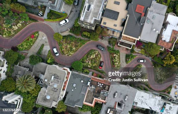 In an aerial view, cars drive along the Lombard Street tourist destination on June 14, 2021 in San Francisco, California. California, the first state...