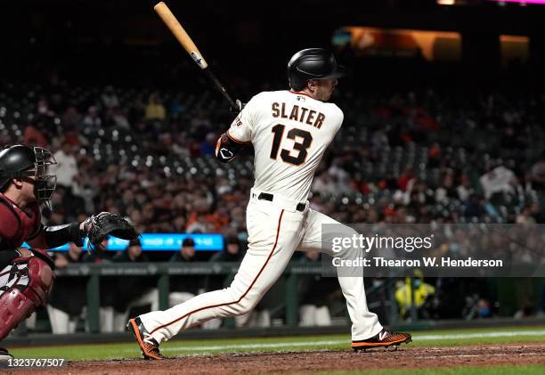 Austin Slater of the San Francisco Giants hits an RBI single scoring Steven Duggar against the Arizona Diamondbacks in the bottom of the eighth...