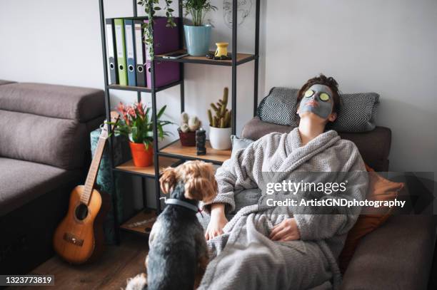 frau mit spa-behandlung zu hause - gesichtsmaske stock-fotos und bilder