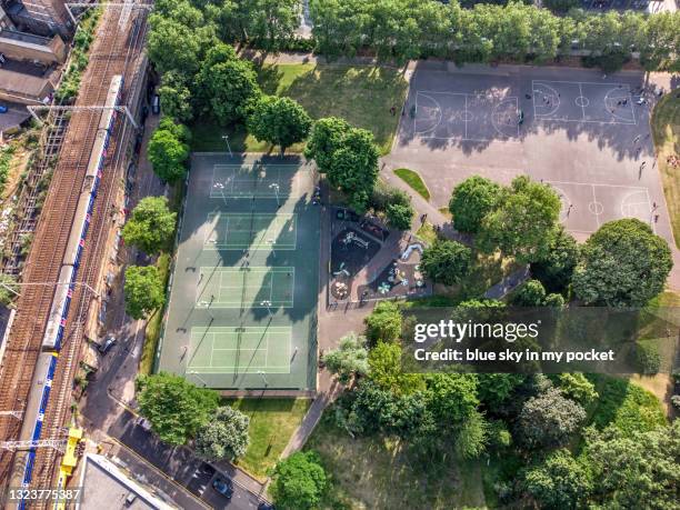 directly above the tennis and basketball courts in bethnal green park, london - bethnal green stock pictures, royalty-free photos & images