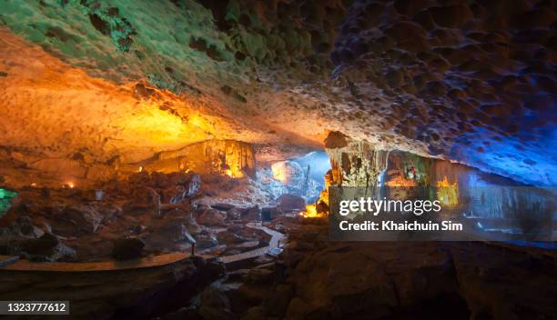 hang sung sot ( surprise cave ) limestone cave with colourful lights illuminate - halong bay stock pictures, royalty-free photos & images