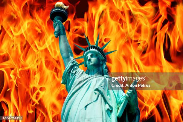 statue of liberty on the background of the flame. - riot fire stock pictures, royalty-free photos & images