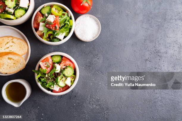 bowls with vegetable salad for healthy eating - greek salad stock pictures, royalty-free photos & images
