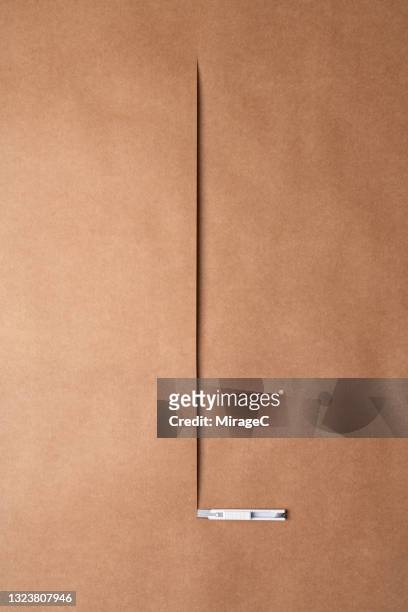 utility knife cutting brown kraft paper - craft knife stock pictures, royalty-free photos & images
