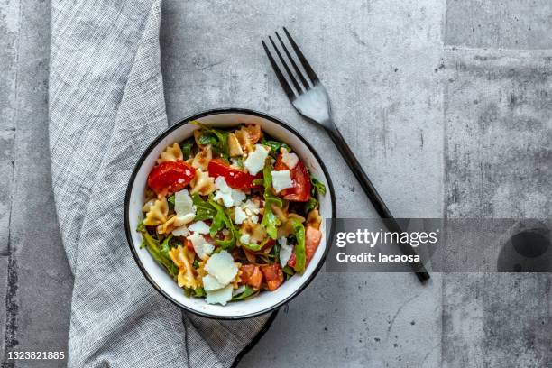 pasta salad with tomatoes, arugula and parmesan - pasta salad stock pictures, royalty-free photos & images