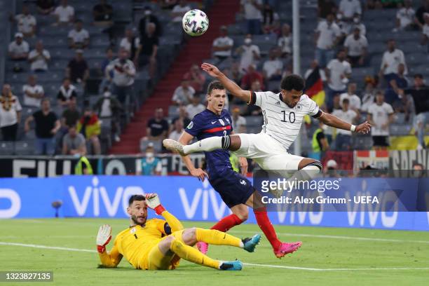 Serge Gnabry of Germany is challenged by goalkeeper Hugo Lloris and Benjamin Pavard of France during the UEFA Euro 2020 Championship Group F match...