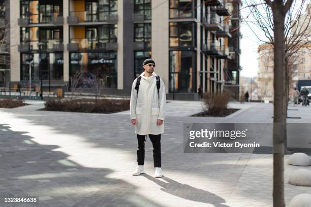 stylish attractive man in the monochrome outfit in the sun - fashion men ストックフォトと画像