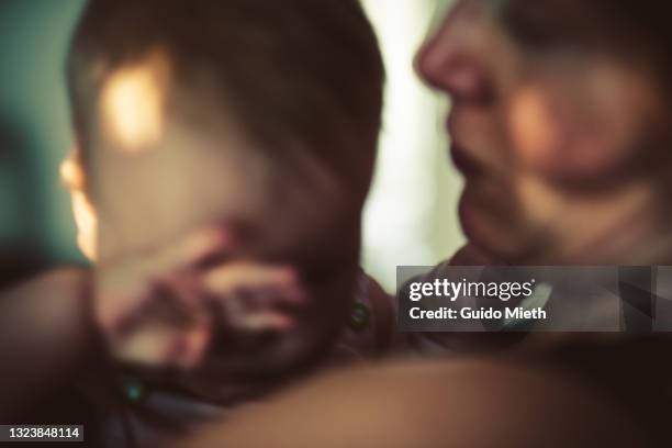 portrait of tired baby girl and her mother. - dark baby stock pictures, royalty-free photos & images