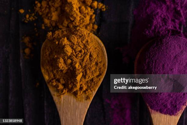 colourful various herbs and spices for cooking on dark background - allspice stockfoto's en -beelden