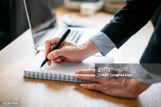 a pair of male hands were writing with a pen - stenographie stock-fotos und bilder