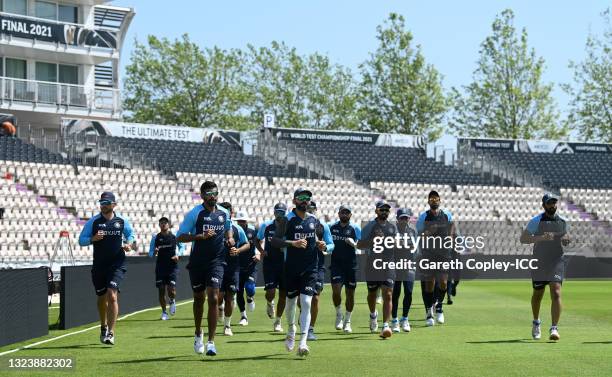 India captain Virat Kohli leads his team as they warm up during a nets session at The Ageas Bowl on June 16, 2021 in Southampton, England.