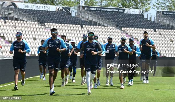 India captain Virat Kohli leads his team as they warm up during a nets session at The Ageas Bowl on June 16, 2021 in Southampton, England.