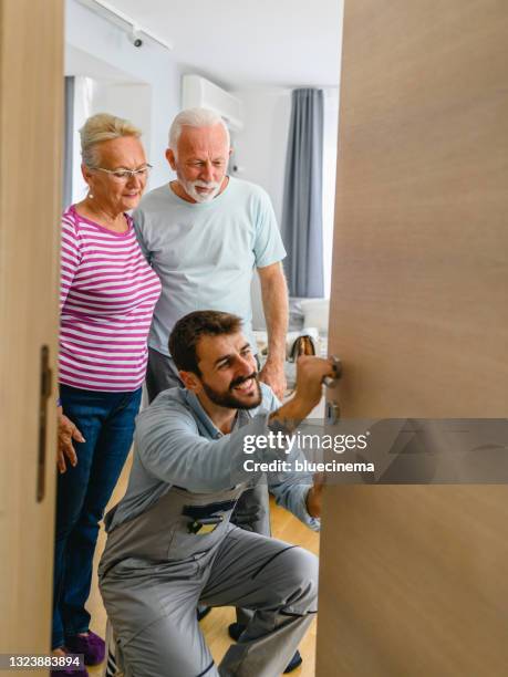 locksmith working with house door lock using screwdriver - locksmith stock pictures, royalty-free photos & images