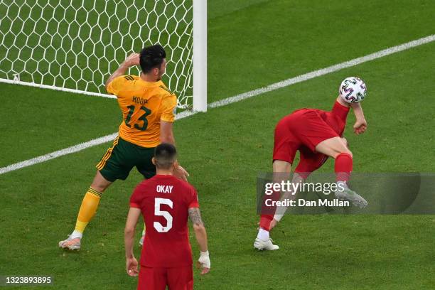 Caglar Soyuncu of Turkey attempts to clear the ball whilst under pressure from Kieffer Moore of Wales during the UEFA Euro 2020 Championship Group A...