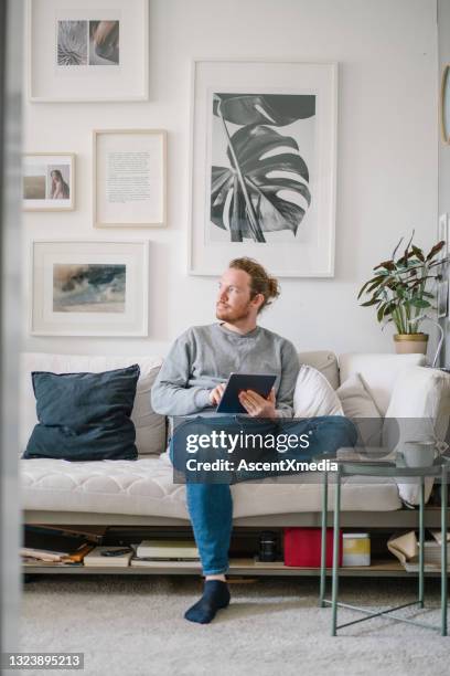 young man works online from living room - connected mindfulness work stock pictures, royalty-free photos & images