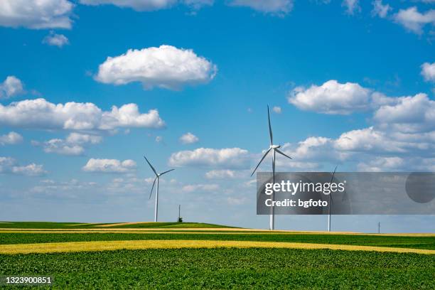 wind turbines on a beautiful field - climate finance stock pictures, royalty-free photos & images