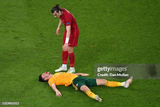 Kieffer Moore of Wales goes down injured after a challenge from Caglar Soyuncu of Turkey during the UEFA Euro 2020 Championship Group A match between...