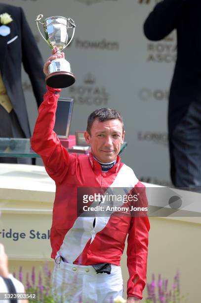 Frankie Dettori holds the winners trophy presented by Prince Edward, Earl of Wessex after he ran Indie Angel to victory in the Duke of Cambridge...