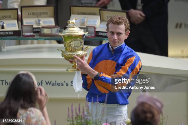 Ryan Moore holds the trophy after riding Love to victory in the Prince Of Wales's Stakes during Royal Ascot 2021 at Ascot Racecourse on June 16, 2021...