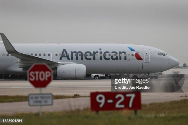 An American Airlines plane taxis after landing on the runway at the Miami International Airport on June 16, 2021 in Miami, Florida. Miami...