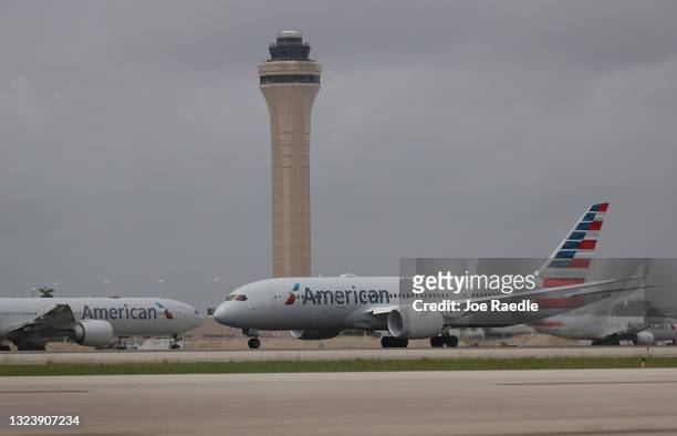 An American Airlines plane takes off in front of the control tower at the Miami International Airport on June 16, 2021 in Miami, Florida. Miami...