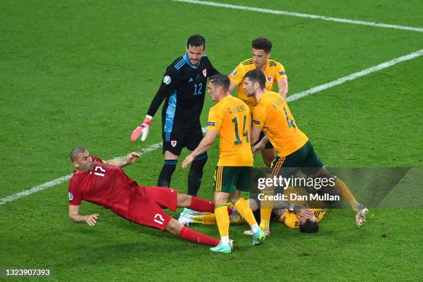 Burak Yilmaz of Turkey falls to the ground as he clashes with Connor Roberts, Ben Davies, Ethan Ampadu and Danny Ward of Wales during the UEFA Euro...