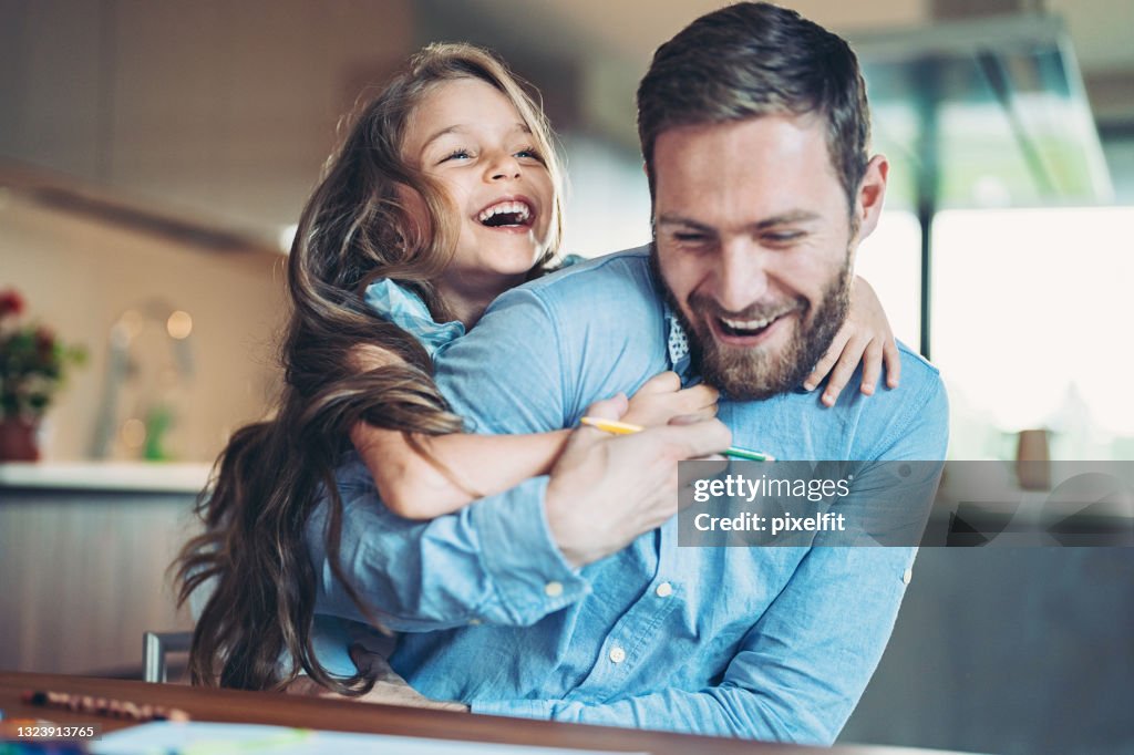 Father and daughter having fun at home