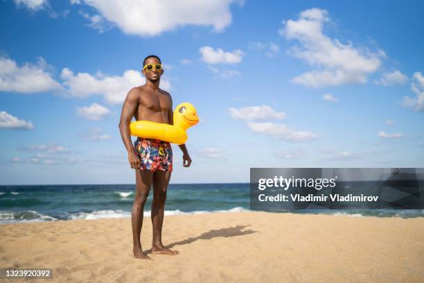 one man standing on an empty beach - end of summer stock pictures, royalty-free photos & images