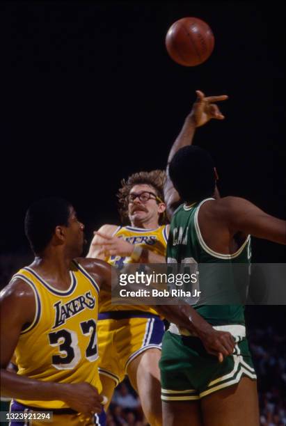 Los Angeles Lakers Kurt Rambis and Magic Johnson battle for ball with Boston Celtics Robert Parish during 1985 NBA Finals between Los Angeles Lakers...