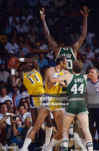 Los Angeles Lakers Bob McAdoo looks for an open play around Boston Celtic Robert Parish during 1985 NBA Finals between Los Angeles Lakers and Boston...