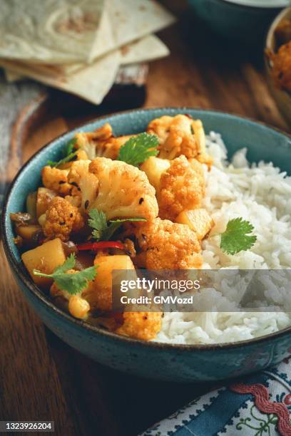 indian vegan aloo gobi dish with potatoes and cauliflower - curry stock pictures, royalty-free photos & images