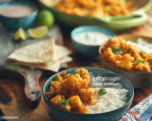 indian vegan aloo gobi dish with potatoes and cauliflower - garam masala stock pictures, royalty-free photos & images