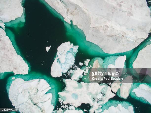 aerial view of icebergs in jakobshavn icefjord, ilulissat, greenland - iceberg above and below water stock pictures, royalty-free photos & images
