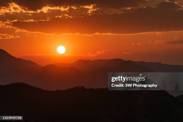 gorgeous sunset and mountain view in pan zhi hua city, china - hot summer nights film stock-fotos und bilder