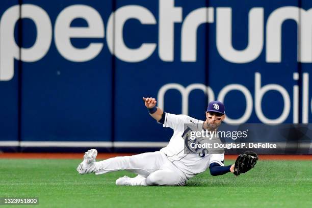 Kevin Kiermaier of the Tampa Bay Rays catches a fly ball during the third inning against the Baltimore Orioles at Tropicana Field on June 11, 2021 in...