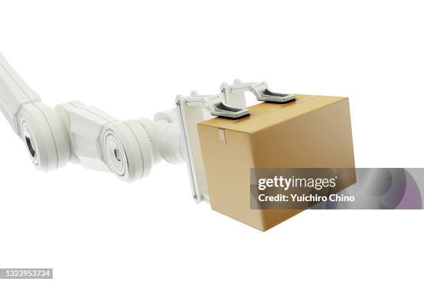 robot arm holding a cardboard box - robot arm stock-fotos und bilder