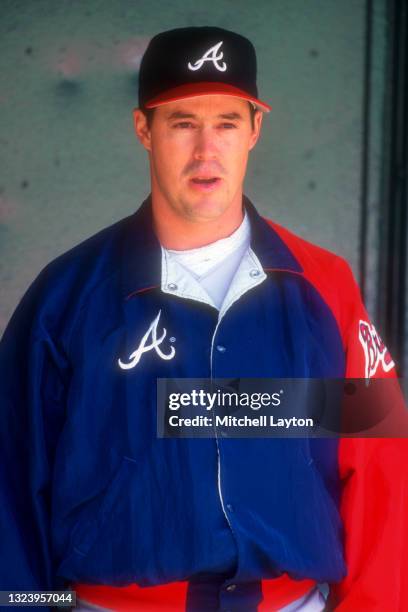 Greg Maddux of the Atlanta Braves looks on during a baseball game against the Philadelphia Phillies on May 12, 1996 at Veterans Stadium in...