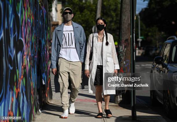 Co-founder of CAALO, Jordan Claridge wearing a CAALO jacket, Nina Las Vegas top, CAALO mask, REI hat, vintage shoes and Burberry sunglasses seen with...