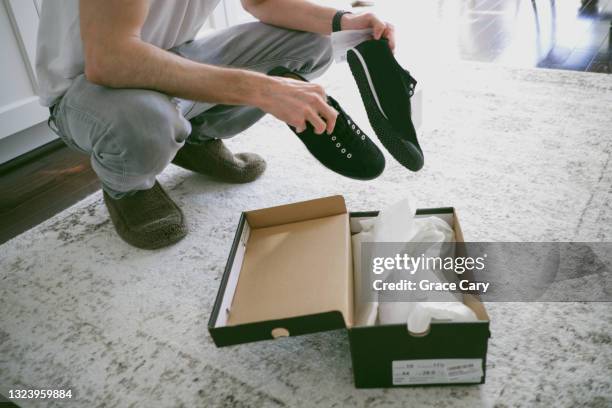 man unboxes new sports shoes - shoes box stock pictures, royalty-free photos & images