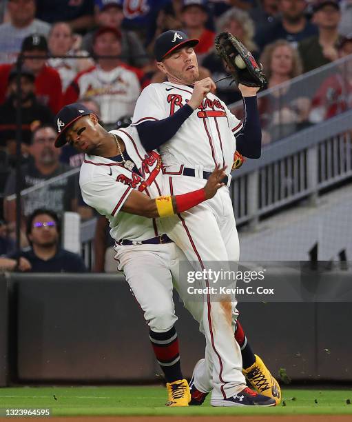 Freddie Freeman of the Atlanta Braves catches a pop out by Hunter Renfroe of the Boston Red Sox as Ronald Acuna Jr. #13 collides with him in the...