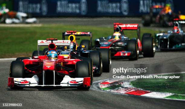 Spanish Scuderia Ferrari Formula One driver Fernando Alonso driving his F150˚ racing car through the Variante Ascari chicane ahead of Sebastian...